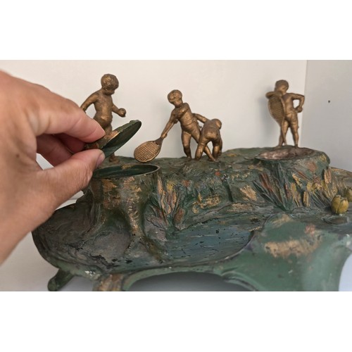 88 - Antique inkwell depicting a cherub's with racquets scene