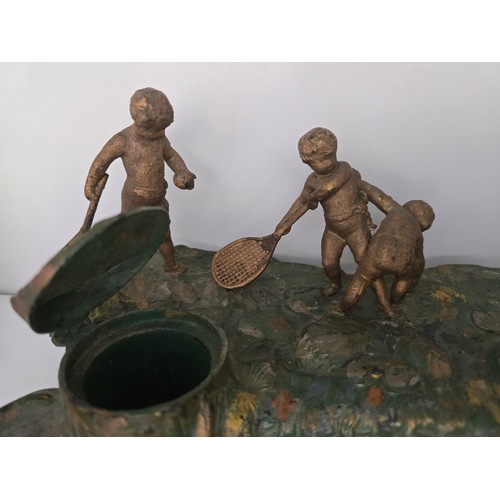 88 - Antique inkwell depicting a cherub's with racquets scene