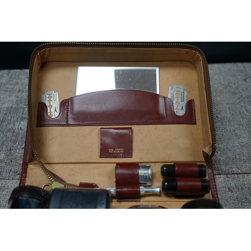 196 - Vintage gents grooming set with original leather case, includes mirror, razor, and blade holders, ma... 