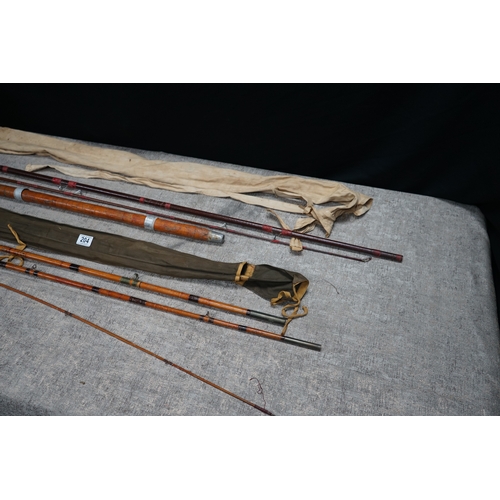 204 - Collection of vintage bamboo fishing rods with protective cases.