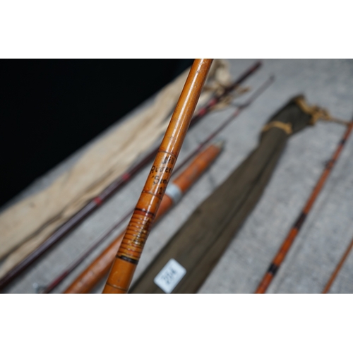 204 - Collection of vintage bamboo fishing rods with protective cases.