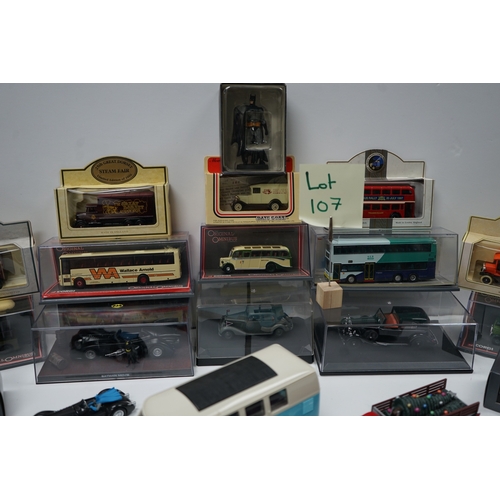 107 - Collection of model vehicles and figurines including buses, cars, motorcycles, and a Batman figure.