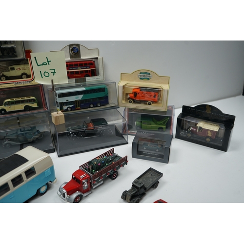 107 - Collection of model vehicles and figurines including buses, cars, motorcycles, and a Batman figure.