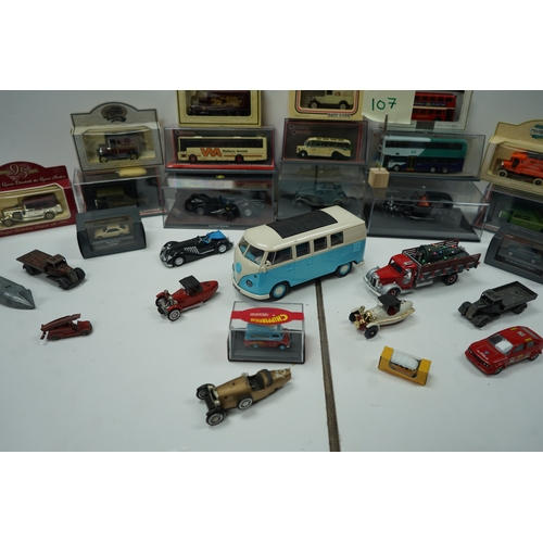 107 - Collection of model vehicles and figurines including buses, cars, motorcycles, and a Batman figure.