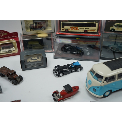 107 - Collection of model vehicles and figurines including buses, cars, motorcycles, and a Batman figure.