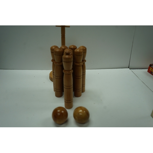 431 - Wooden lawn bowling set with pins and balls on a stand.