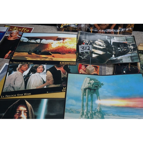 312 - Collection of movie and TV show memorabilia including Star Wars figures, Indiana Jones poster, Buffy... 