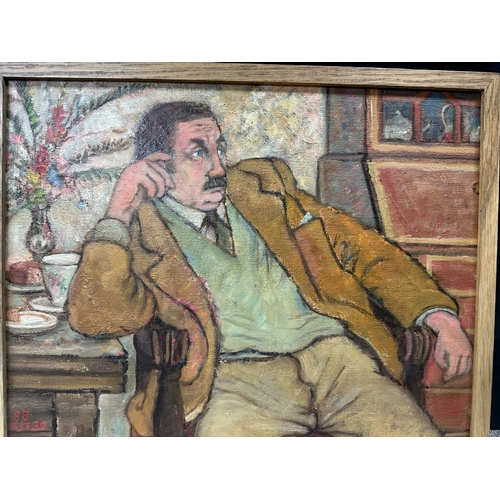 2s - Peter Samuelson (British 1912-1996) Framed Oil on Board- A seated man leaning on a table by a sidebo... 