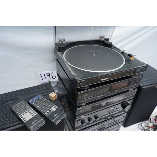 1196 - Collection of Sony stereo components, including two speakers, a turntable, multiple audio units, rem... 