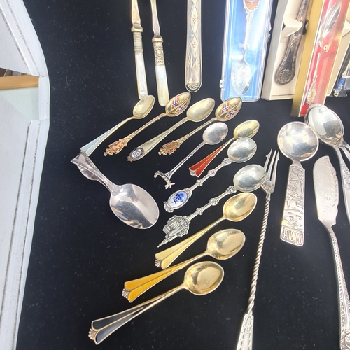 75a - Collection of vintage and ornate cutlery.  Assortment includes spoons, forks, knives, serving utensi... 