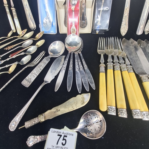 75a - Collection of vintage and ornate cutlery.  Assortment includes spoons, forks, knives, serving utensi... 