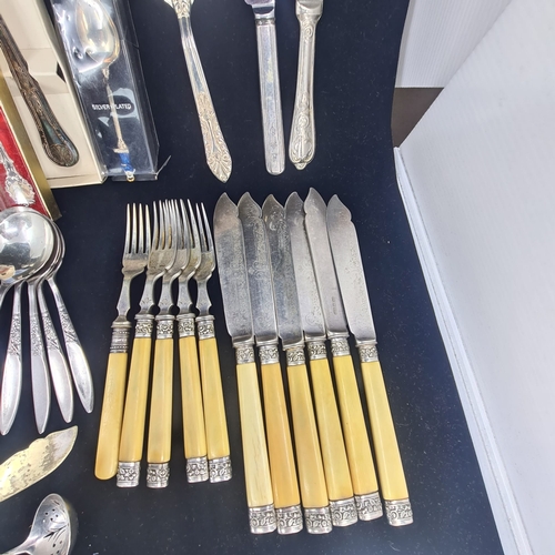 75a - Collection of vintage and ornate cutlery.  Assortment includes spoons, forks, knives, serving utensi... 