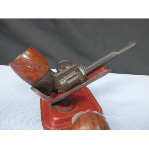 98 - Novelty Revolver tobacco pipe resting on a stand plus one other