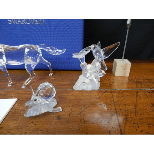 43 - Mint & Boxed 9.5cm Swarovski Horse (5135910) together with Three unboxed Swarovski Figures