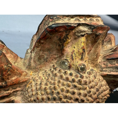 276 - A 15th/16th Century Ayuthia Period Seated Stone Buddha, thickly covered with lacques, red paint & go... 