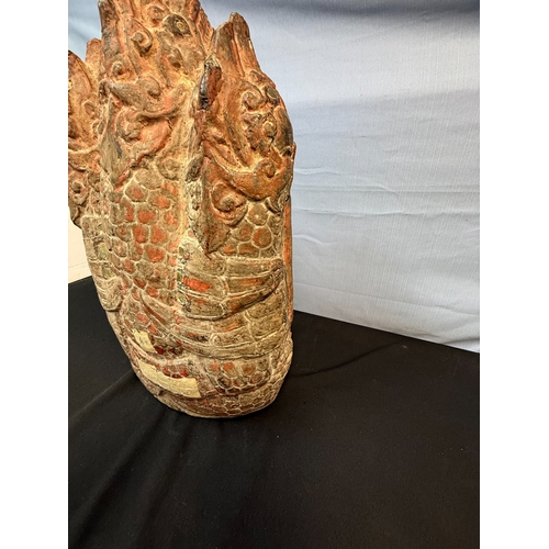 276 - A 15th/16th Century Ayuthia Period Seated Stone Buddha, thickly covered with lacques, red paint & go... 