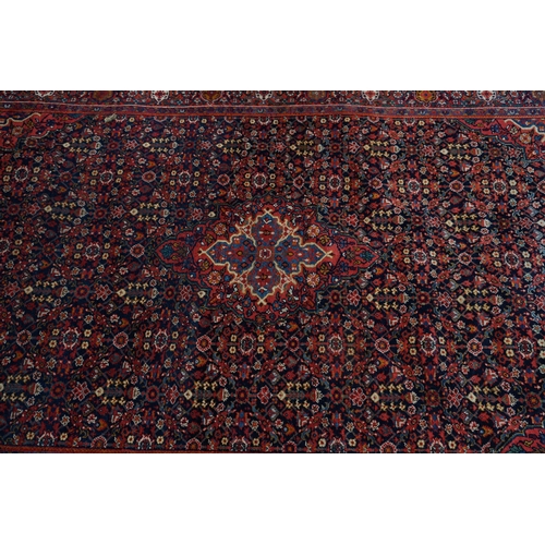 1D - A Persian Sarouk Rug with Herati Design to to central pale blue medallion and indigo field. The main... 