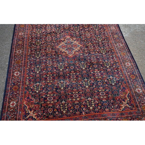 1D - A Persian Sarouk Rug with Herati Design to to central pale blue medallion and indigo field. The main... 