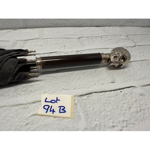 94B - An Alexander McQueen Umbrella featuring the designer's iconic silver-tone skull handle.