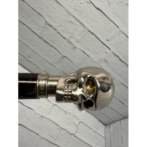 94B - An Alexander McQueen Umbrella featuring the designer's iconic silver-tone skull handle.