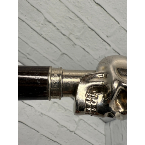 94B - An Alexander McQueen Umbrella featuring the designer's iconic silver-tone skull handle.