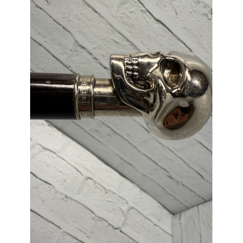 94B - An Alexander McQueen Umbrella featuring the designer's iconic silver-tone skull handle.