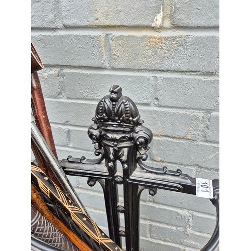 101 - A collection of antique and vintage walking sticks in an ornate cast iron stand to include a duck-he... 