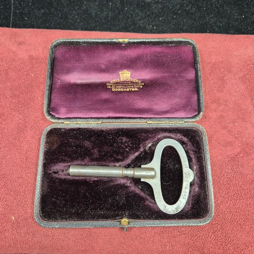 22J - A Cased Clock Key with Hallmarked Silver Plaque to 