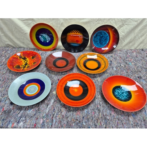 A Set of Nine Plates by Alan Clarke for Poole Pottery to commemorate the alignment of the Planets on the 5th May 2000 (diameter approx 26.5cm) each signed to the underside