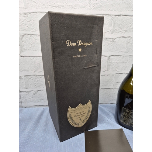 731 - A 75cl Bottle of Dom Perignon 2004 Champagne with Box and Booklet