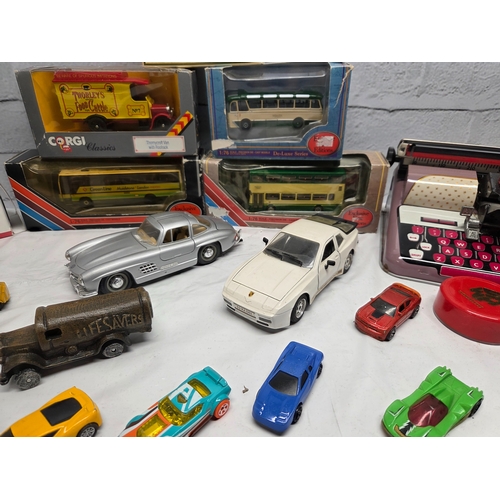 668D - A mixed lot of vintage and collectable items to include die-cast model vehicles including boxed Eddi... 