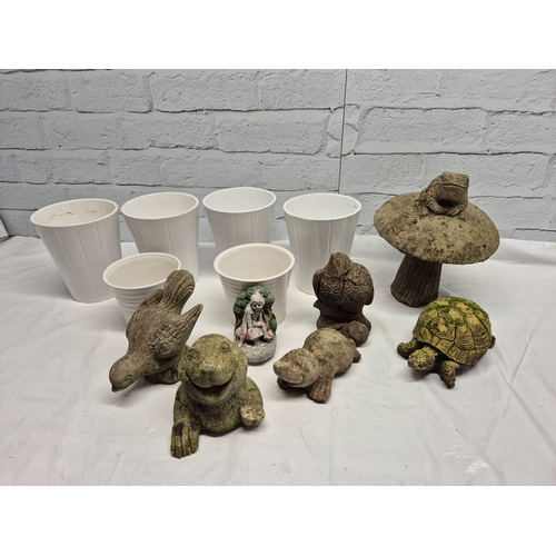 665A - A Collection of weathered Garden Ornaments together with six Flowerpots