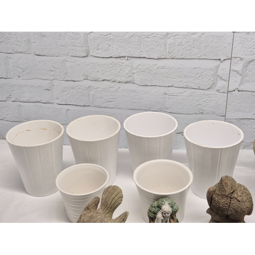 665A - A Collection of weathered Garden Ornaments together with six Flowerpots