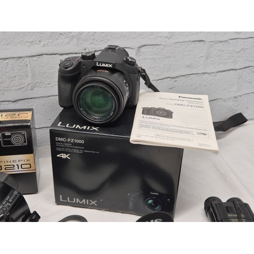 675C - A Collection of Modern Cameras/Equipment to include Panasonic Lumix DMC-FZ1000, Nikon Coolpix P7000,... 
