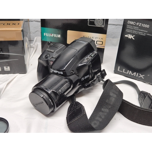 675C - A Collection of Modern Cameras/Equipment to include Panasonic Lumix DMC-FZ1000, Nikon Coolpix P7000,... 