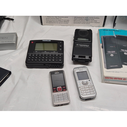 678C - A Collection of Classic Electronics to include to include Nokia Phones, Motorolla Flip Phone, Sealed... 