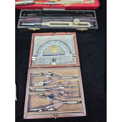 Collection of vintage drafting tool sets, including compasses ...