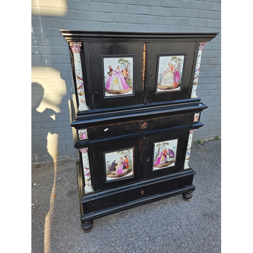 A 19th century Continental ebonised cabinet mounted with porcelain plaques