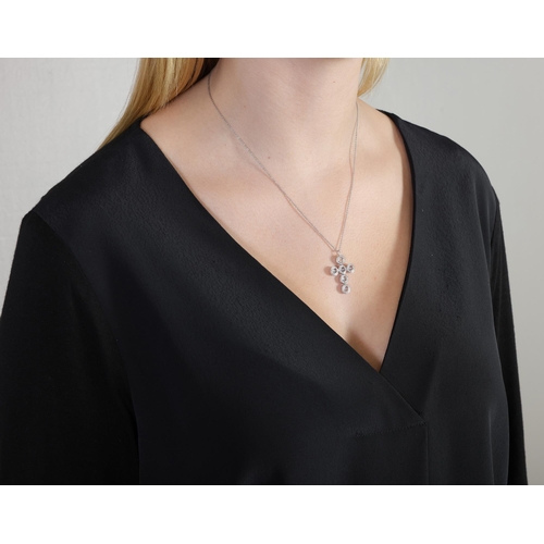 18 - A TOPAZ AND DIAMOND PENDANT NECKLACE, the pendant designed as a cross, reversibly mounted with circu... 