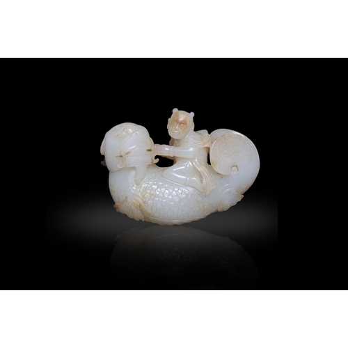 105 - A WHITE JADE AND RUSSET 'BOY RIDING THE DRAGON-FISH' GROUP  ?? ??????  China, Ming dynasty  Size. 5 ... 