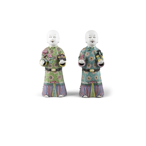 99 - A PAIR OF CHINESE POLYCHROME PORCELAIN FIGURES OF HOHO BROTHERS HOLDING AUSPICIOUS OBJECTS  ?? ?????... 