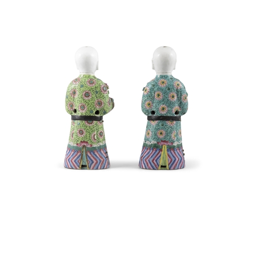 99 - A PAIR OF CHINESE POLYCHROME PORCELAIN FIGURES OF HOHO BROTHERS HOLDING AUSPICIOUS OBJECTS  ?? ?????... 