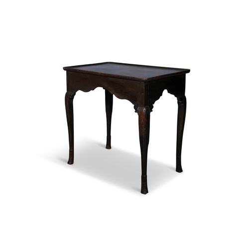 100 - AN 18TH CENTURY MAHOGANY AND OAK SIDE TABLE,  the rectangular tray top and shaped apron raised on ca... 