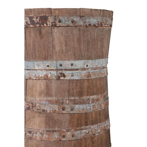 104 - AN OAK AND METAL BOUND BUTTER CHURN,  of coopered construction. 89cm high