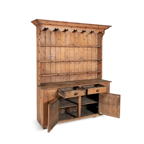 145 - A 19TH CENTURY WELSH DRESSER,  the top section with moulded canope cornice, above three shelves, wit... 