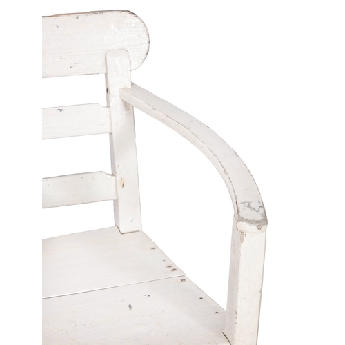 153 - A WHITE PAINTED PINE ARCMCHAIR  with ladder back and slightly bowed armrests, panelled seat and squa... 