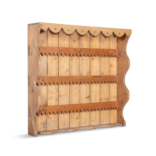 160 - A STRIPPED PINE OPEN HANGING WALL RACK WITH DECORATIVE FRIEZE,   94cm high, 100cm wide, 21cm deep.