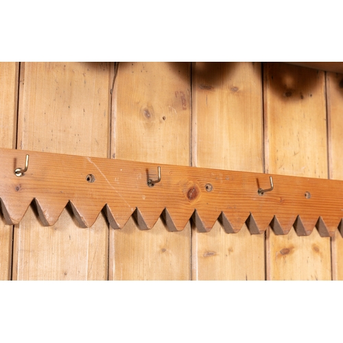 160 - A STRIPPED PINE OPEN HANGING WALL RACK WITH DECORATIVE FRIEZE,   94cm high, 100cm wide, 21cm deep.