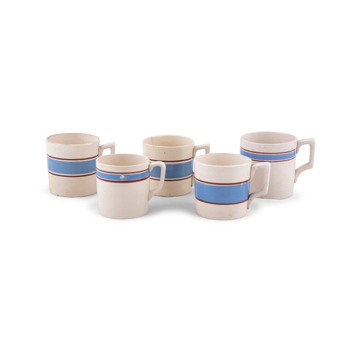 216 - FIVE CARRIGALINE POTTERY MUGS WITH BLUE BAND.   the largest 9cm