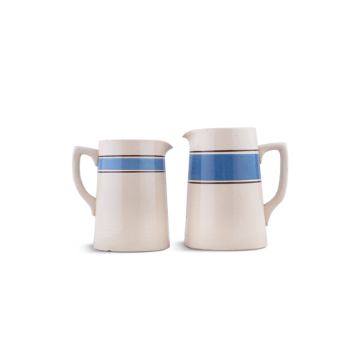 218 - TWO CARRIGALINE POTTERY JUGS, BLUE BAND.   17cm wide